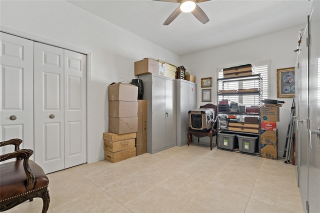 office with a ceiling fan and light tile patterned floors