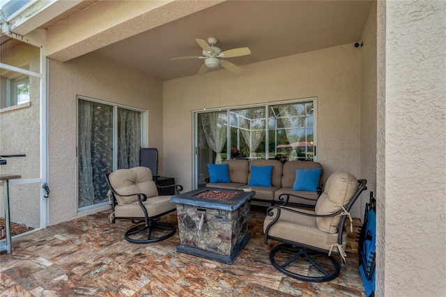 view of patio / terrace with a ceiling fan and a fire pit