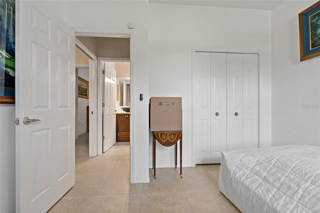 bedroom featuring light tile patterned floors and a closet
