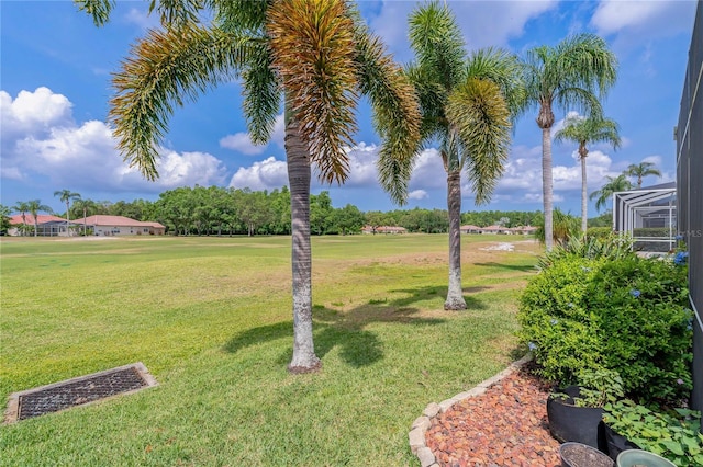 view of green lawn featuring golf course view