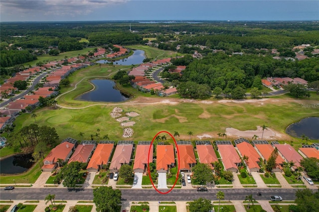aerial overview of property's location with a large body of water, a local golf course, and nearby suburban area