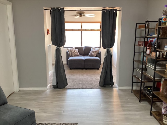 13111 Sheridan Dr, Hudson, FL 34667 - living room with a ceiling fan, baseboards, and wood finished floors
