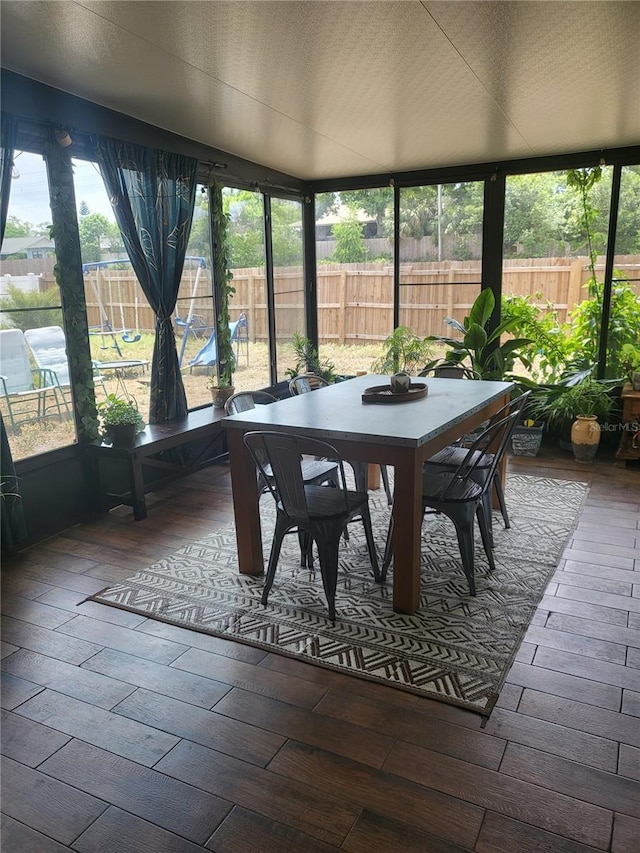 13111 Sheridan Dr, Hudson, FL 34667 - sunroom / solarium featuring outdoor dining space, wood-type flooring, and healthy amount of natural light