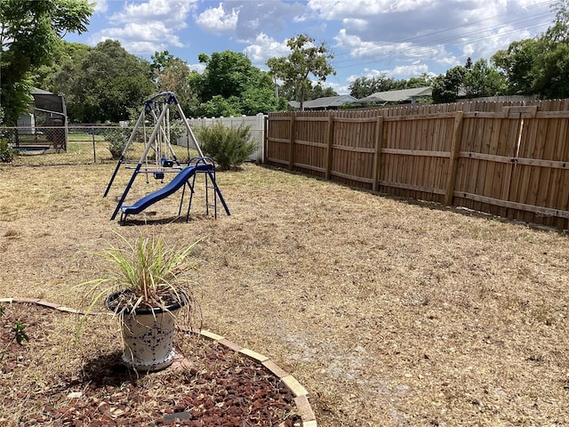 13111 Sheridan Dr, Hudson, FL 34667 - fenced backyard with a playground