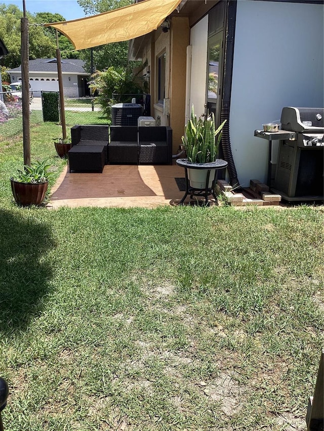 13111 Sheridan Dr, Hudson, FL 34667 - view of grassy yard featuring a patio area, outdoor lounge area, and central AC unit