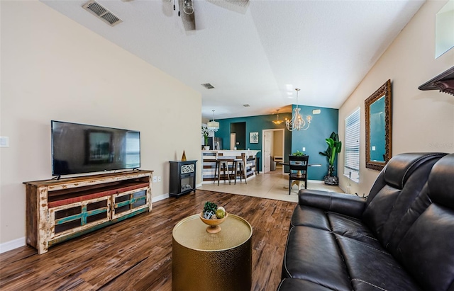 8604 Corinthian Way, New Port Richey, FL 34654 - living room featuring a chandelier, wood finished floors, vaulted ceiling, ceiling fan, and baseboards