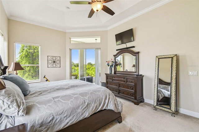 bedroom featuring multiple windows, light carpet, a tray ceiling, and access to outside