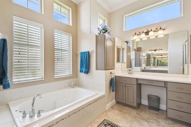 bathroom featuring crown molding, a high ceiling, vanity, tile patterned floors, and a garden tub