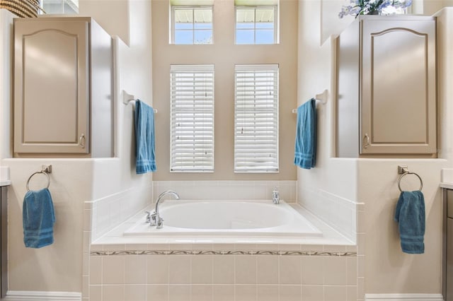 bathroom featuring vanity and a bath