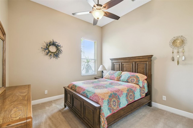 bedroom with baseboards, a ceiling fan, and light carpet
