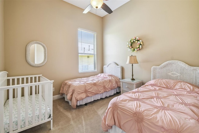 carpeted bedroom with baseboards and ceiling fan