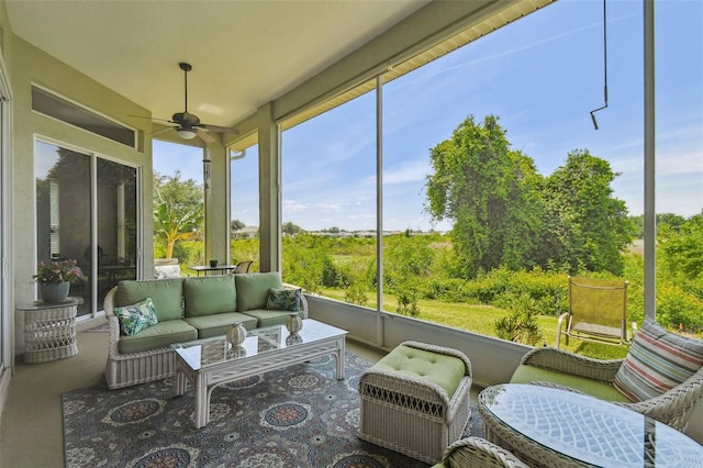 sunroom / solarium with an outdoor living space and a ceiling fan
