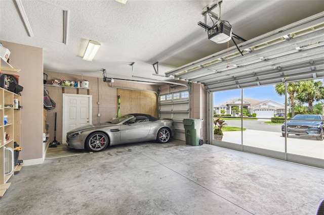 garage featuring concrete block wall and a garage door opener