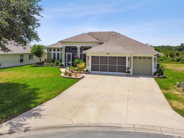 view of front of property featuring an attached garage, stucco siding, driveway, and a front yard