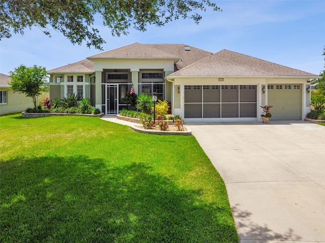 prairie-style house featuring an attached garage, a front lawn, stucco siding, and driveway