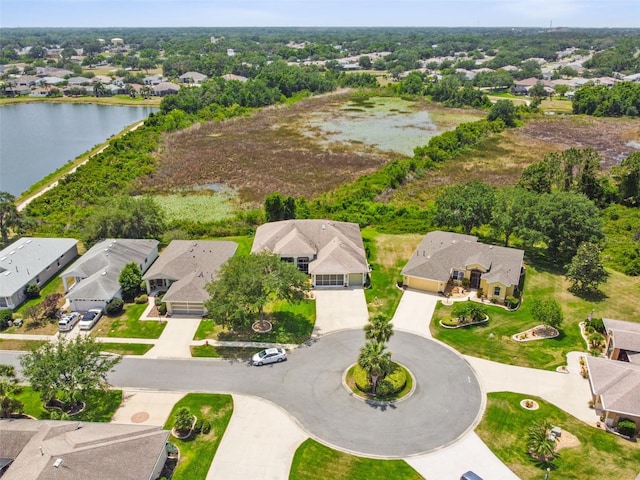 drone / aerial view featuring a water view and a residential view