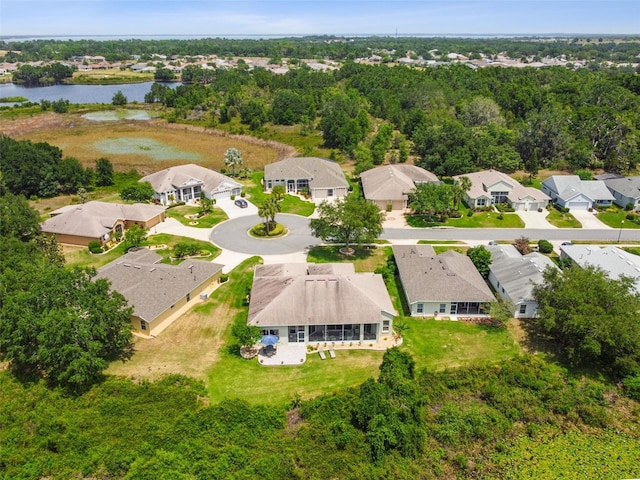 drone / aerial view with a water view and a residential view