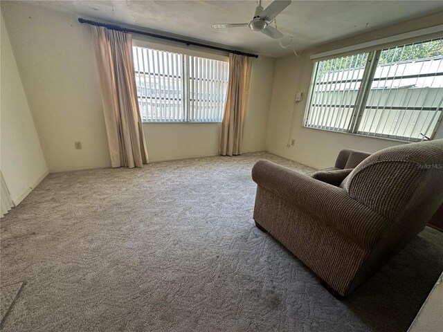 sitting room featuring a ceiling fan and carpet flooring