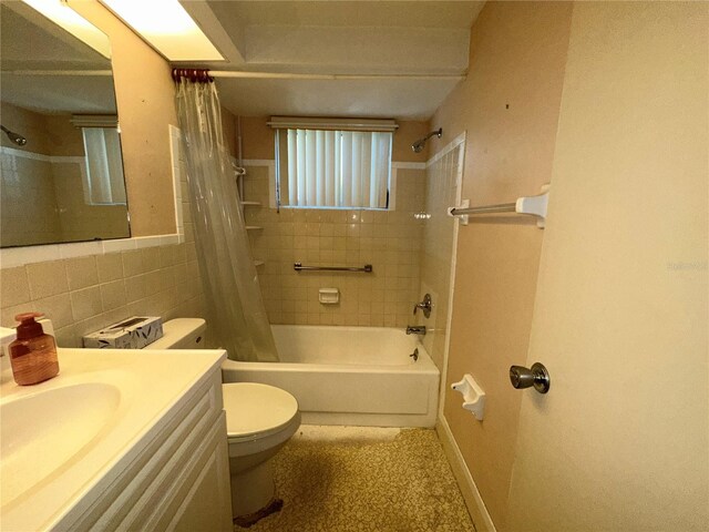 full bath with toilet, tile walls, shower / bathtub combination with curtain, and vanity
