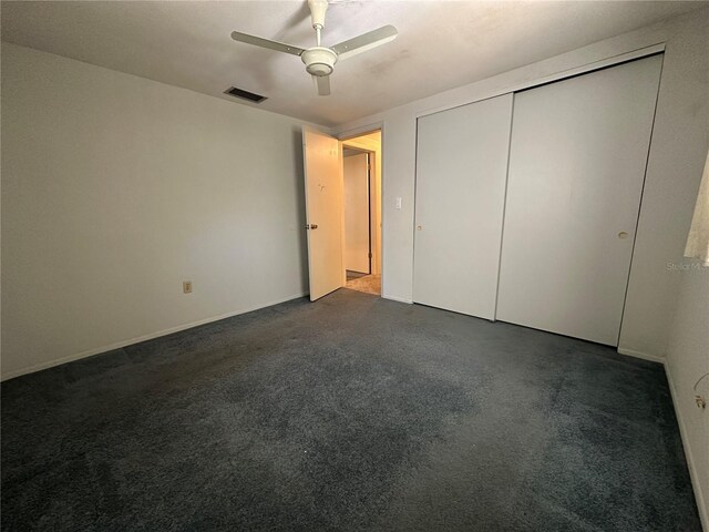 unfurnished bedroom featuring a ceiling fan, visible vents, and a closet