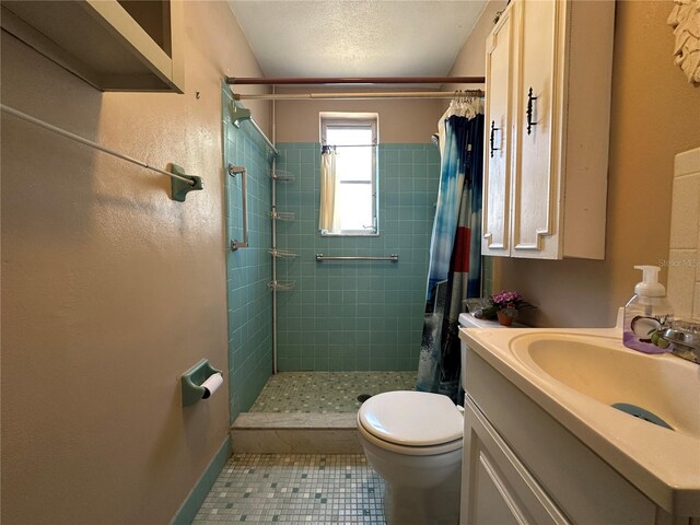full bathroom with tile patterned flooring, vanity, toilet, baseboards, and a stall shower