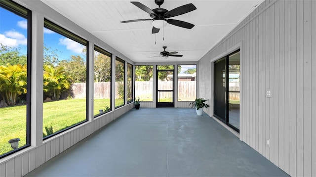 unfurnished sunroom with a ceiling fan