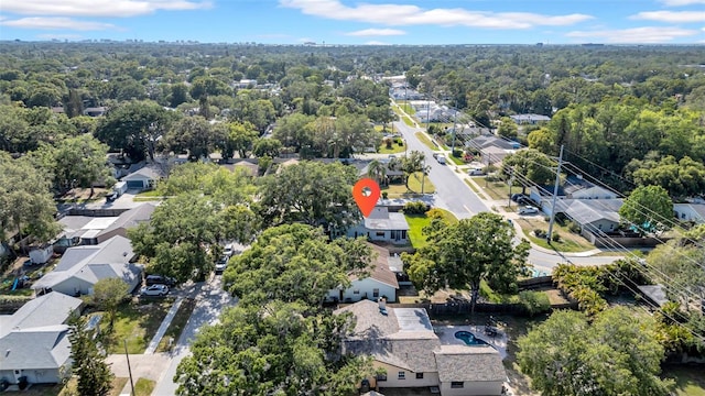 birds eye view of property with a residential view and a wooded view