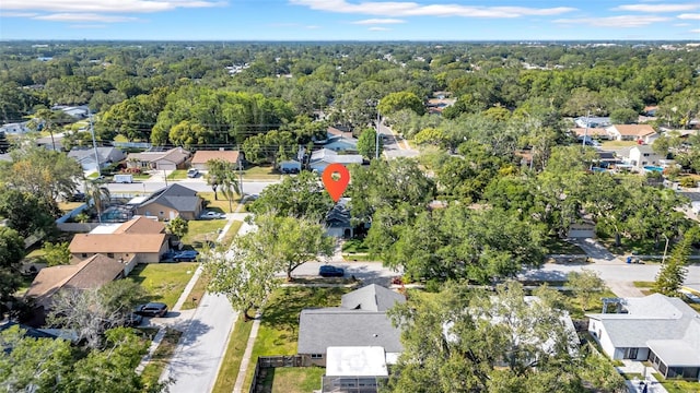 bird's eye view featuring a wooded view and a residential view