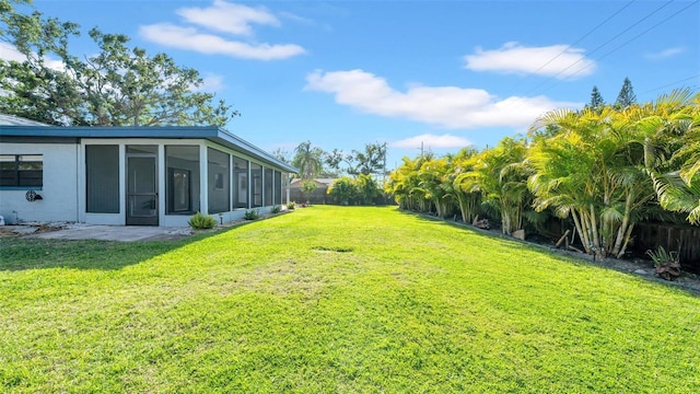 view of yard with a sunroom and fence private yard