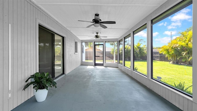 unfurnished sunroom featuring a ceiling fan