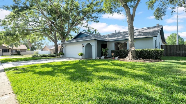 single story home with a garage, fence, a front yard, stucco siding, and concrete driveway