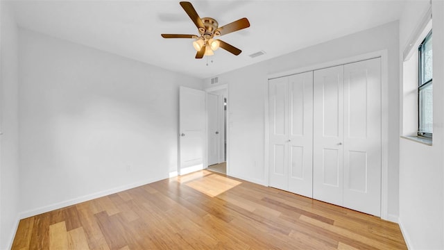 unfurnished bedroom with baseboards, visible vents, and light wood finished floors