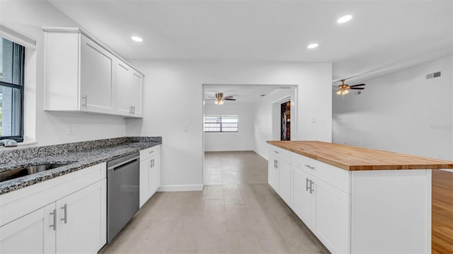 kitchen with ceiling fan, butcher block countertops, a sink, and dishwasher
