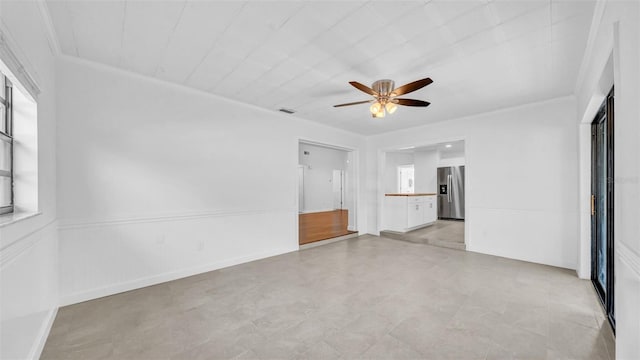 unfurnished bedroom with stainless steel fridge, a ceiling fan, and connected bathroom
