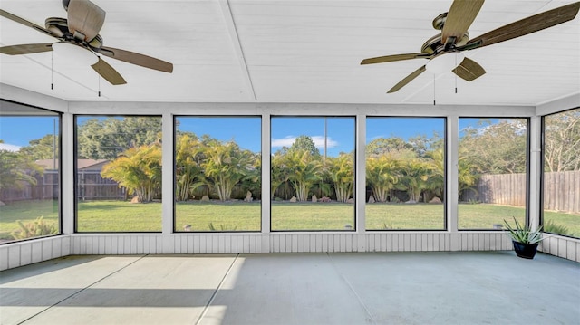 unfurnished sunroom with ceiling fan