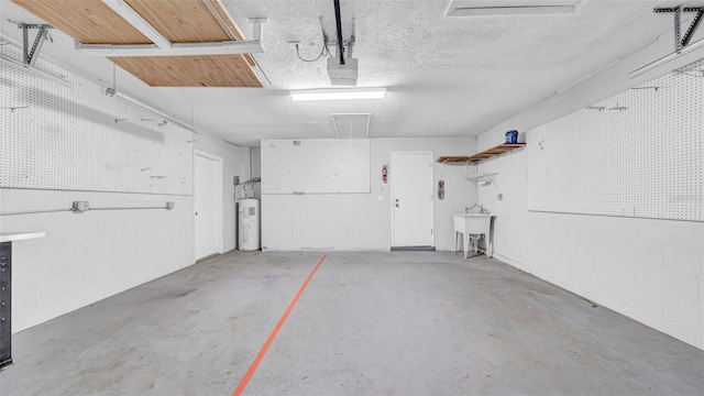 garage featuring a sink, a garage door opener, and water heater