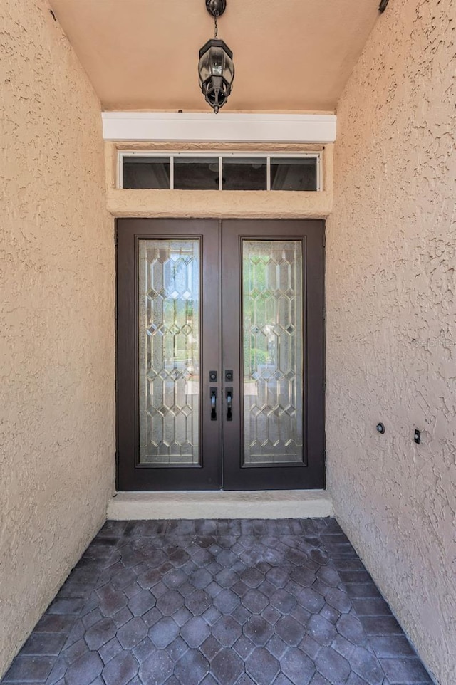 1033 Tuscany Dr, Trinity, FL 34655 - doorway to property with french doors and stucco siding