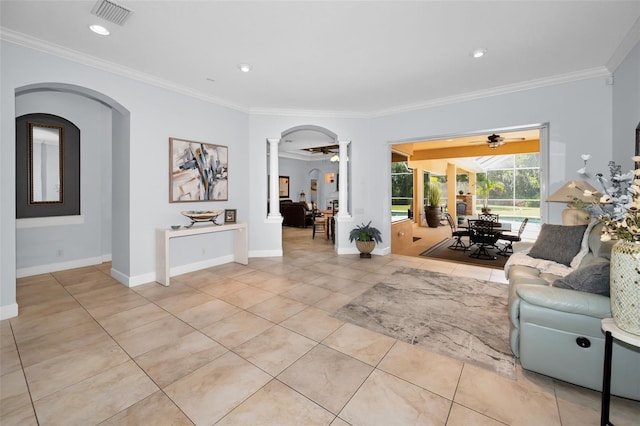 1033 Tuscany Dr, Trinity, FL 34655 - living room featuring ceiling fan, arched walkways, light tile patterned floors, ornate columns, and visible vents