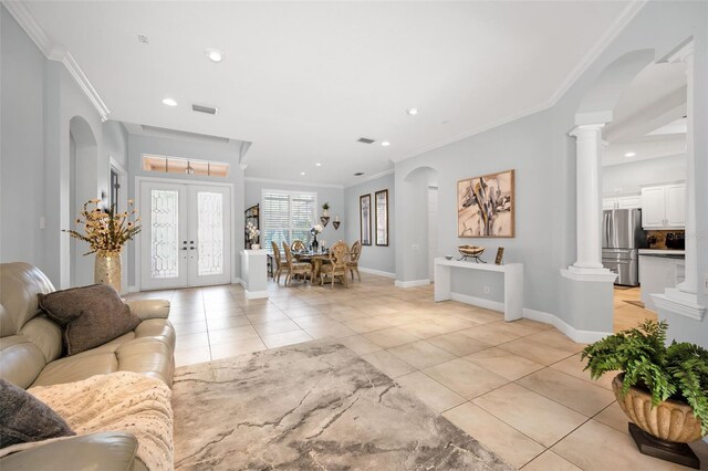 1033 Tuscany Dr, Trinity, FL 34655 - foyer entrance featuring crown molding, arched walkways, light tile patterned floors, ornate columns, and recessed lighting