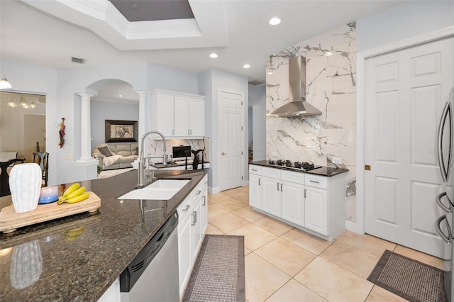 1033 Tuscany Dr, Trinity, FL 34655 - kitchen featuring visible vents, wall chimney range hood, ornate columns, a sink, and appliances with stainless steel finishes