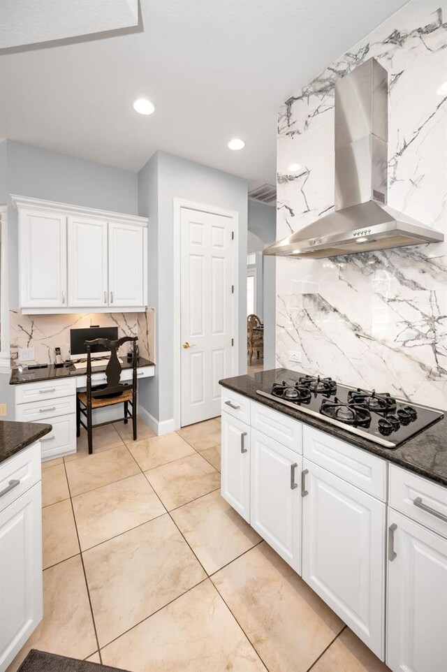 1033 Tuscany Dr, Trinity, FL 34655 - kitchen featuring wall chimney range hood, white cabinetry, tasteful backsplash, light tile patterned floors, and black gas stovetop
