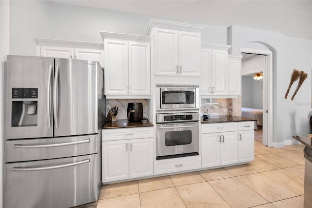 1033 Tuscany Dr, Trinity, FL 34655 - kitchen with white cabinetry, appliances with stainless steel finishes, and tasteful backsplash
