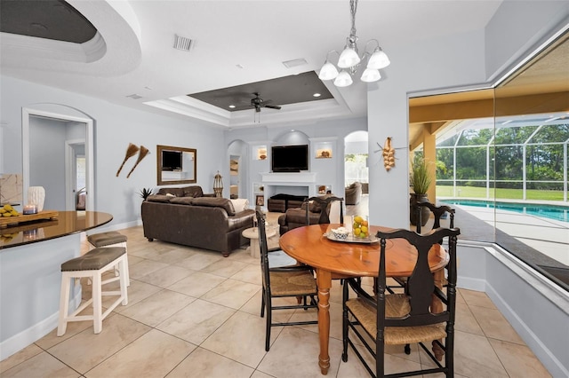 1033 Tuscany Dr, Trinity, FL 34655 - dining space with visible vents, arched walkways, light tile patterned floors, a raised ceiling, and ceiling fan with notable chandelier