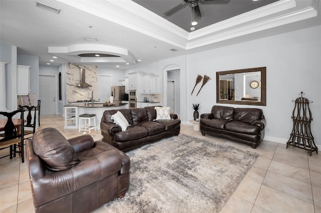 1033 Tuscany Dr, Trinity, FL 34655 - living room featuring visible vents, arched walkways, a raised ceiling, and a ceiling fan