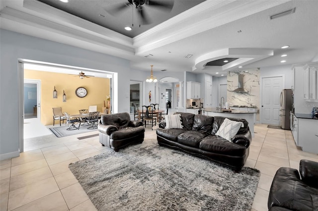1033 Tuscany Dr, Trinity, FL 34655 - living area featuring a ceiling fan, visible vents, light tile patterned floors, and a raised ceiling