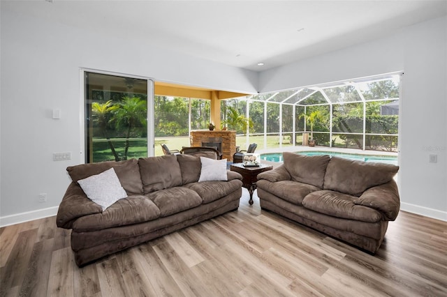 1033 Tuscany Dr, Trinity, FL 34655 - living room with a healthy amount of sunlight, baseboards, and a sunroom