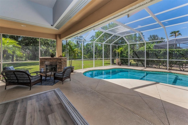 1033 Tuscany Dr, Trinity, FL 34655 - outdoor pool featuring a yard, a patio, a lanai, and an outdoor living space with a fireplace
