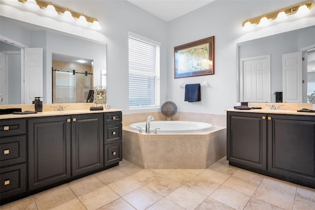 1033 Tuscany Dr, Trinity, FL 34655 - full bath featuring a garden tub, two vanities, tile patterned floors, a shower stall, and a sink
