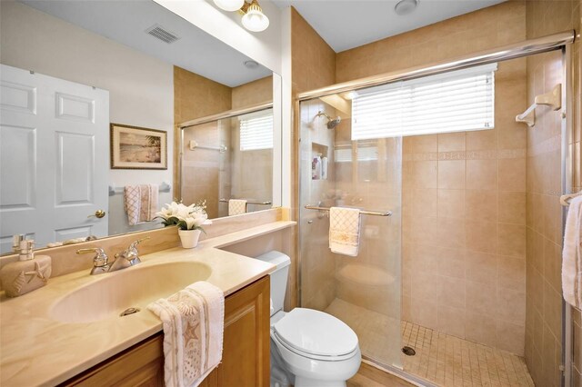 1033 Tuscany Dr, Trinity, FL 34655 - full bathroom featuring visible vents, a stall shower, a healthy amount of sunlight, and toilet