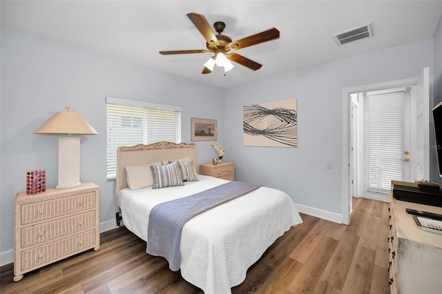 1033 Tuscany Dr, Trinity, FL 34655 - bedroom featuring baseboards, a ceiling fan, wood finished floors, and visible vents